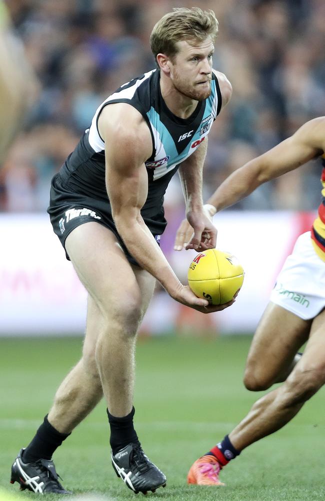 Port’s Tom Jonas gets a handpass away as Adelaide’s Eddie Betts closes in. Picture: Sarah Reed