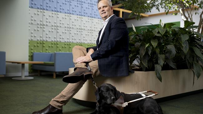 Vision Australia government relations and advocacy manager Chris Edwards with his dog Eva. Picture: Arsineh Houspian