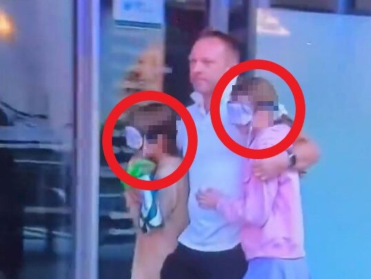 A father put masks over the eyes of his children as he exited the Westfield.