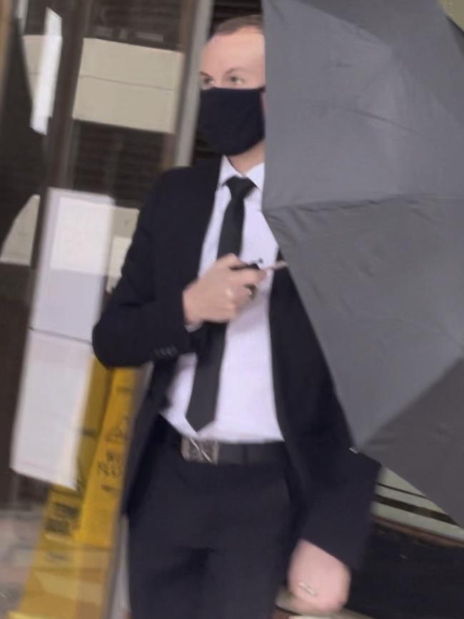 A camera-shy Scott James Edwards leaves court.