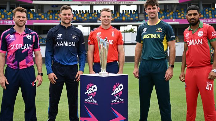 BRIDGETOWN, BARBADOS - JUNE 01: Group B captains Richie Berrington of Scotland, Gerhard Erasmus of Namibia, Jos Buttler of England, Mitchell Marsh of Australia and Aqib Ilyas of Oman pose with the trophy as part of the ICC Men's T20 Cricket World Cup West Indies & USA 2024 at Kensington Oval on June 01, 2024 in Bridgetown, Barbados. (Photo by Gareth Copley/Getty Images)