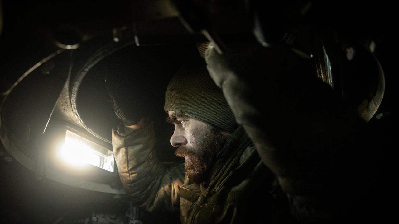 A member of a Ukrainian artillery unit watches out from inside a M109 self propelled artillery unit as they come under Russian shelling. Picture: Chris McGrath/Getty Images