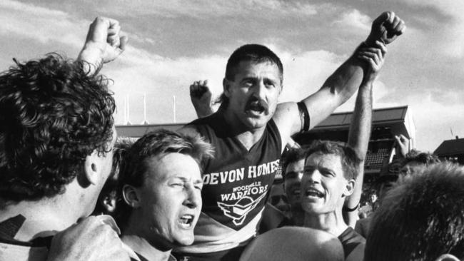 Ralph Sewer is carried from the ground on the shoulders of his Woodville team-mates after his final game against West Torrens in 1990.