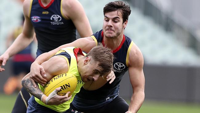 Adelaide’s Darcy Fogarty tackles teammate Jordan Gallucci at training. Picture: Sarah Reed