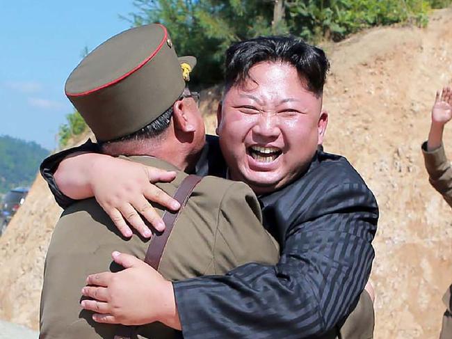 TOPSHOT - This picture taken on July 4, 2017 and released by North Korea's official Korean Central News Agency (KCNA) on July 5, 2017 shows North Korean leader Kim Jong-Un (C) celebrating the successful test-fire of the intercontinental ballistic missile Hwasong-14 at an undisclosed location. South Korea and the United States fired off missiles on July 5 simulating a precision strike against North Korea's leadership, in response to a landmark ICBM test described by Kim Jong-Un as a gift to "American bastards". / AFP PHOTO / KCNA VIA KNS / STR / South Korea OUT / REPUBLIC OF KOREA OUT   ---EDITORS NOTE--- RESTRICTED TO EDITORIAL USE - MANDATORY CREDIT "AFP PHOTO/KCNA VIA KNS" - NO MARKETING NO ADVERTISING CAMPAIGNS - DISTRIBUTED AS A SERVICE TO CLIENTS THIS PICTURE WAS MADE AVAILABLE BY A THIRD PARTY. AFP CAN NOT INDEPENDENTLY VERIFY THE AUTHENTICITY, LOCATION, DATE AND CONTENT OF THIS IMAGE. THIS PHOTO IS DISTRIBUTED EXACTLY AS RECEIVED BY AFP.    /