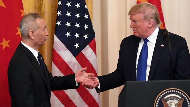 President Donald Trump shook hands with Chinese Vice Premier Liu He upon signing a January 2020 trade pact, which preserved certain tariffs US business groups have since called for easing. Picture: AFP