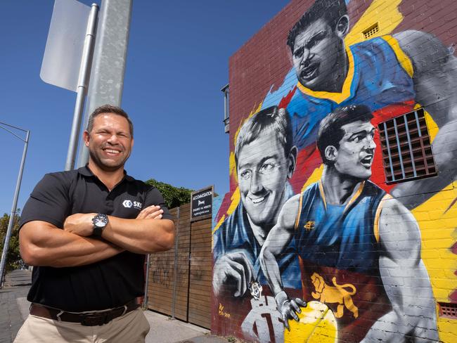 Ex-AFL player Chris Johnson joins Fitzroy greats Kevin Murray and Jon Brown on the famous mural which was only completed on Friday. Picture: Jason Edwards