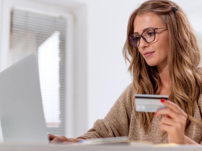 A young woman on her computer using a credit card to pay for goods. Picture: iStock.