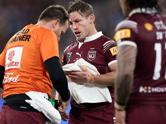 MELBOURNE, AUSTRALIA - JUNE 26:  Harry Grant of the Maroons is attended to by a trainer after a head knock during game two of the men's State of Origin series between New South Wales Blues and Queensland Maroons at the Melbourne Cricket Ground on June 26, 2024 in Melbourne, Australia. (Photo by Cameron Spencer/Getty Images)