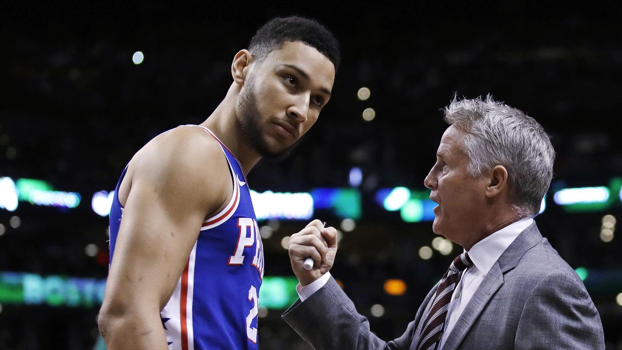 FILE — In this Wednesday, May 9, 2018 file photo,Philadelphia 76ers coach Brett Brown, right, talks with guard Ben Simmons before Game 5 of the team's NBA basketball playoff series against the Boston Celtics in Boston. Philadelphia 76ers coach Brett Brown is expecting more out of guards Ben Simmons and Markelle Fultz this season. The guards failed to hit a 3-pointer last season. Brown says the duo will have to be better from long range this season. (AP Photo/Charles Krupa, File)