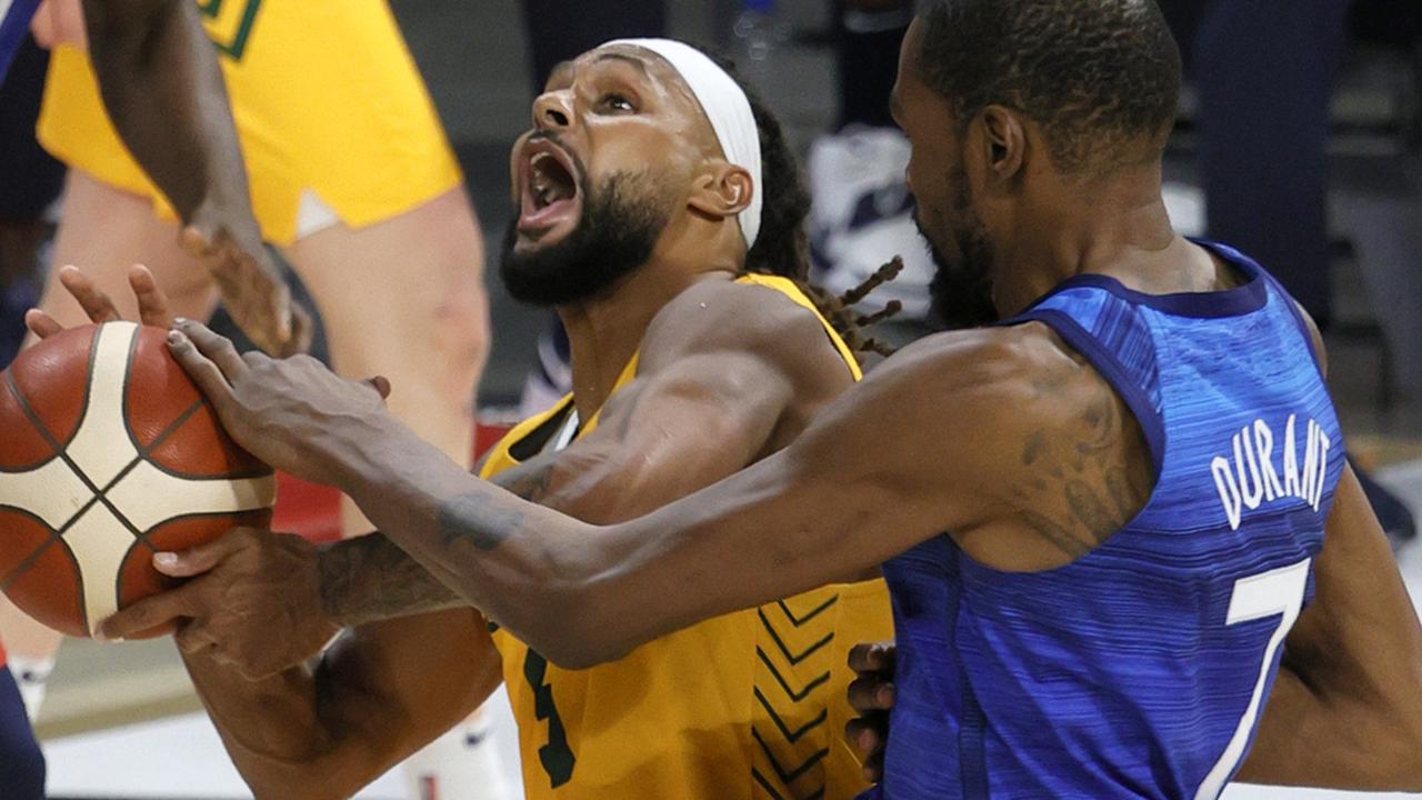 Patty Mills is fouled by Kevin Durant of the United States.