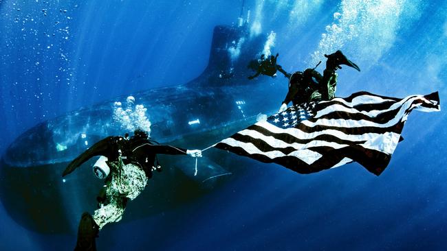 US Naval Special Warfare Group Eight display the national ensign as they perform dive operations while underway on a Virginia Class fast-attack submarine. For Australia, a business-as-usual approach to AUKUS cannot work.