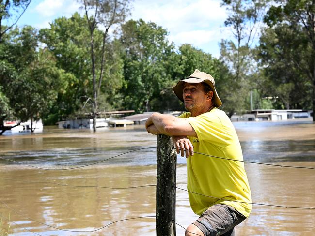 Resident Wayne Smith poses a for photograph with the Dargle Water Ski Resort submerged under floodwater behind him at Sackville North, NSW. Picture: NCA NewsWire/Bianca De Marchi