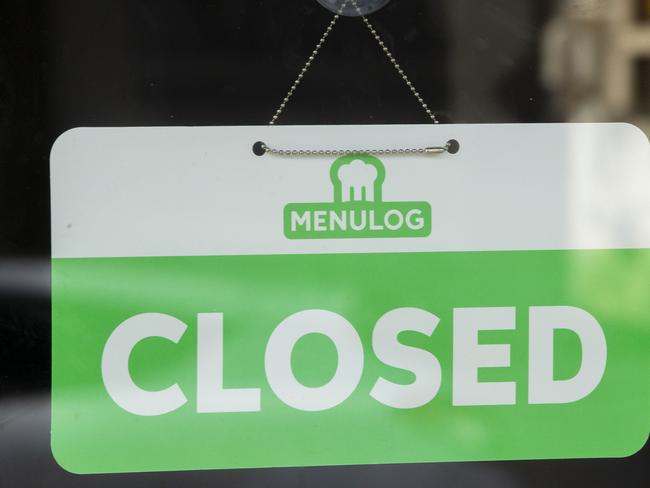 SYDNEY, AUSTRALIA - MAY 07: A menulog closed sign is seen in the window of a restaurant in Newtown on May 07, 2020 in Sydney, Australia. Some retailers are starting to reopen with caution following the easing of restrictions on some non-essential business. The National Cabinet committee is meeting on Friday 8 May to decide whether to relax some coronavirus measures across the country. (Photo by Jenny Evans/Getty Images)