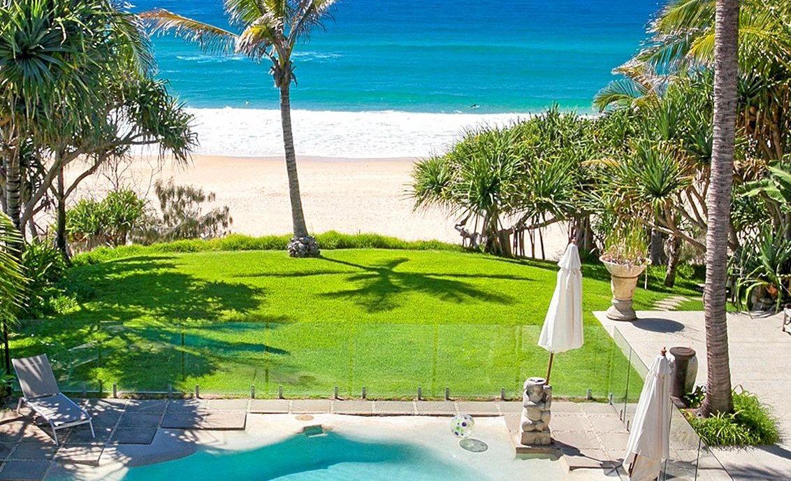 The property overlooks Sunshine Beach, as the backyard lawn meets the sand.