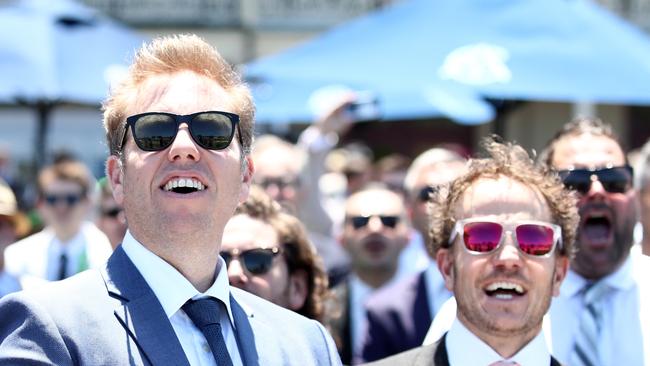 Racegoers watching the Melbourne Cup at Randwick Racecourse in Sydney as the RBA announces another interest rate hike.