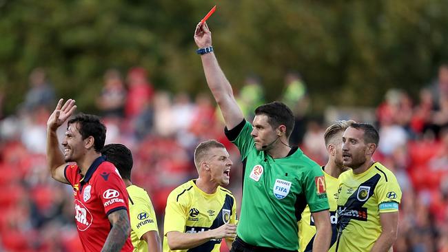 Referee Shaun Evans sends off Adelaide United defender Ersan Gulum.