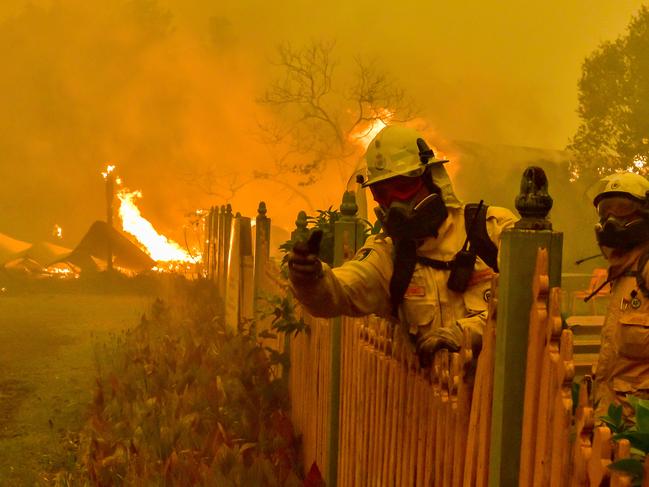 Firefighters scramble to save properties on the Bells Line Rd on Saturday December 21 as the Gospers Mountain fire burned out of control. Picture: Matrix