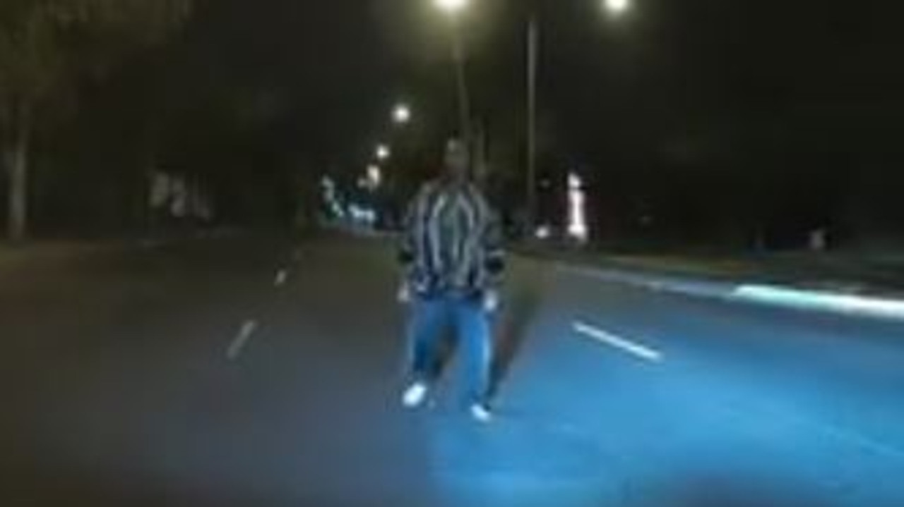 Watch: Man approaches car while driving | The Courier Mail