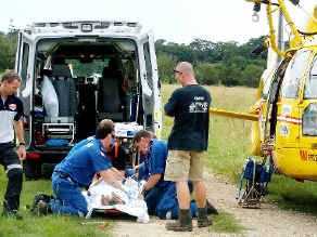 Paramedics work on a woman after a horse accident at Myocum yesterday. . Picture: Westpac Helicopter