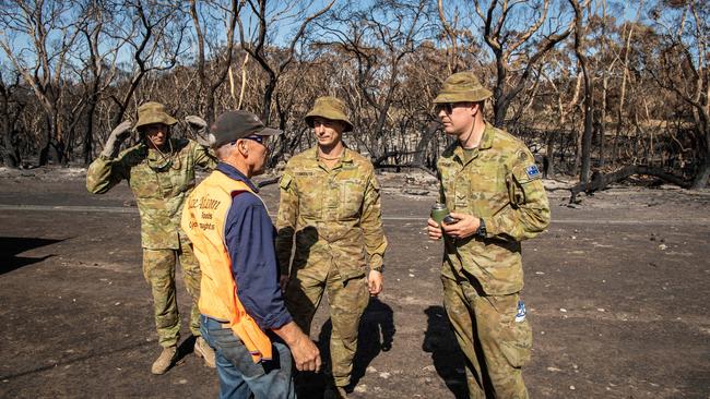 Blaze Aid volunteer Ross Murray working with Army Reservists to replace stock fencing on Josh Graham's property. Picture: Brad Fleet