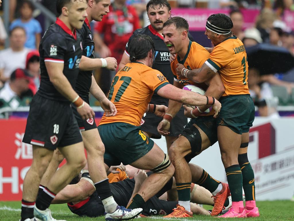 Maurice Longbottom (right) celebrates with Australia teammates. Picture: Mike Lee / World Rugby