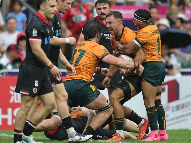 Maurice Longbottom (right) celebrates with Australia teammates. Picture: Mike Lee / World Rugby