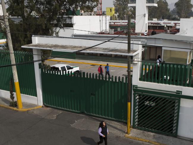 Stay ... A woman walks past the compound of the Agujas immigration detention centre, where U.S. fugitive Ethan Couth is being detained in Mexico City. Picture: AP