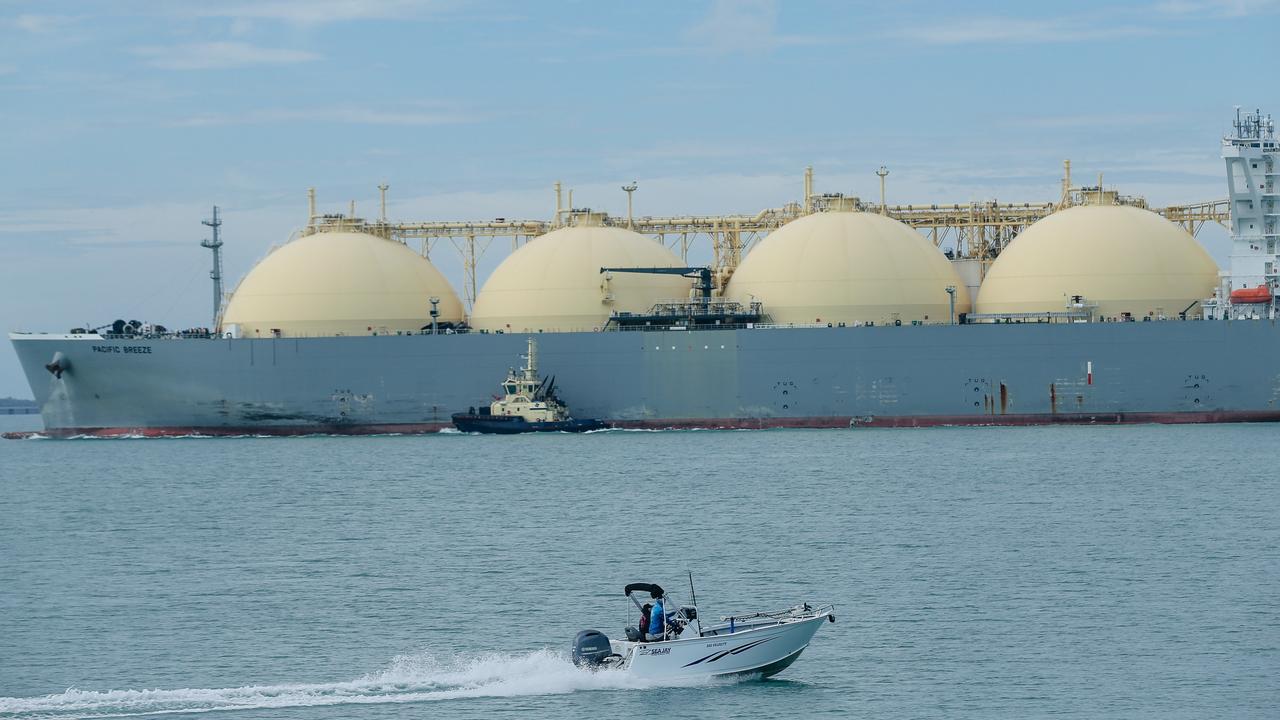 An amateur Fisherman passing an LNG ship in Darwin Harbour. Picture: Glenn Campbell