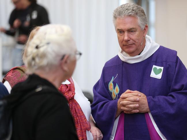 Reverend Dean Lawrence Kimberley speaks with a member of his congregation after a service at the Christchurch Transitional Cathedral.