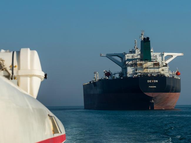 A support vessel maneuvers near the crude oil tanker 'Devon' as it sails through the Persian Gulf towards Kharq Island oil terminal to transport crude oil to export markets in Bandar Abbas, Iran, on Friday, March 23, 2018. Geopolitical risk is creeping back into the crude oil market. Photographer: Ali Mohammadi/Bloomberg