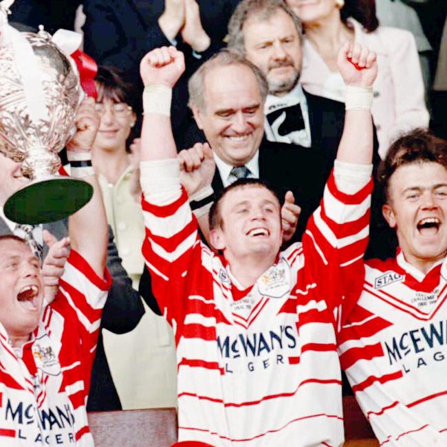 Bobbie Goulding holds up 1996 Silk Cut Challenge Cup trophy.