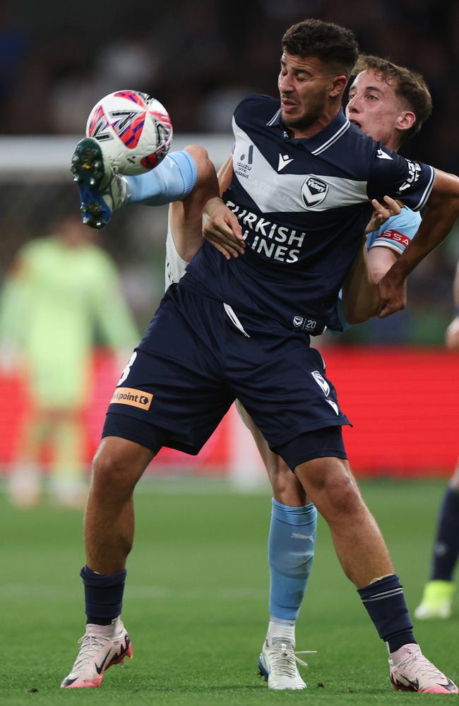 Kai Trewin of Melbourne City kicks the ball under pressure from Zinedine Machach of the Victory at AAMI Park. Picture: Getty Images