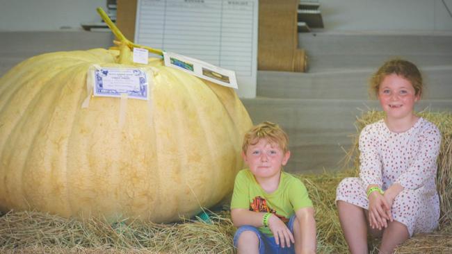 Xavier, 4, and Sienna, 6, Prolongeau with the prize winning pumpkin at the Royal Darwin Show in 2021. Picture: Glenn Campbell