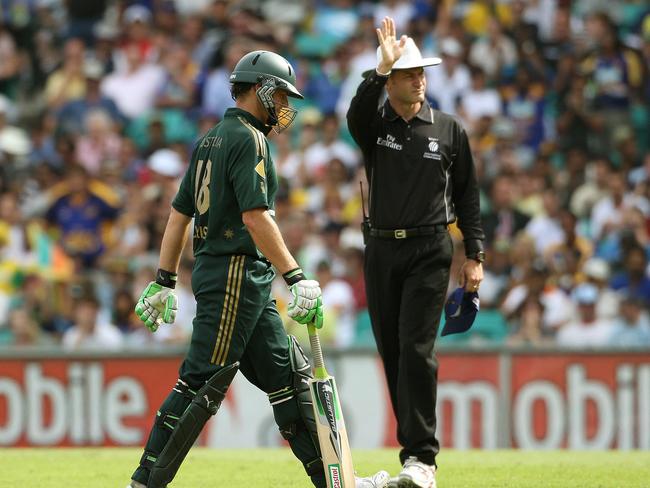 Adam Gilchrist leaving the field after being dismissed, as umpire Simon Taufel gestures to the boundary during a One Day International against Sri Landa in Sydney in 2008.