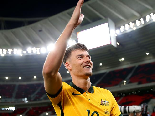 DOHA, QATAR - JUNE 07: Ajdin Hrustic of Australia celebrates after their sides victory during the 2022 FIFA World Cup Playoff match between United Arab Emirates and Australia at Ahmad Bin Ali Stadium on June 07, 2022 in Doha, Qatar. (Photo by Mohamed Farag/Getty Images)