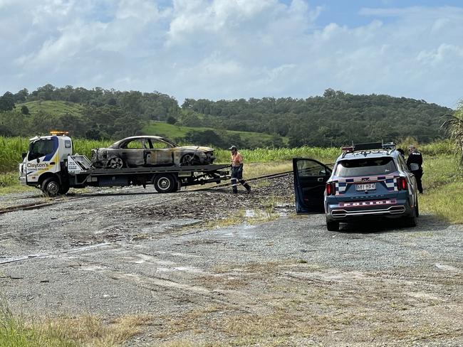 Police and firefighters responded to reports of a burnt out vehicle over a cane train line near Habana. Photo: Fergus Gregg