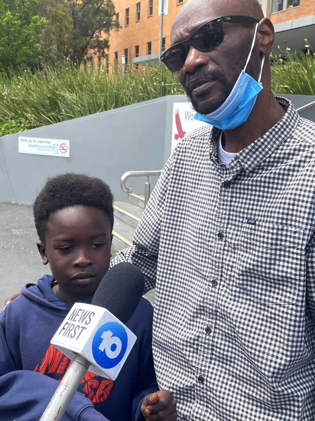 Ibrahim, 8, holds the hand of a relative after visiting his dad at The Alfred. Picture: Miles Proust