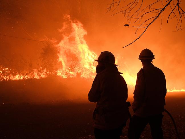 NSW Rural Fire Service crews protecting properties on Kellyknack Road as the Wrights Creek fire approaches Mangrove Mountain north of Sydney. Picture: Dan Himbrechts