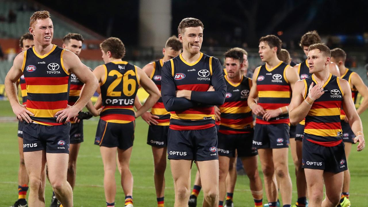 ADELAIDE, AUSTRALIA - JULY 18: Paul Seedsman of the Crows and Tom Lynch along with team mates after the loss during the 2021 AFL Round 18 match between the Adelaide Crows and the West Coast Eagles at Adelaide Oval on July 18, 2021 in Adelaide, Australia. (Photo by Sarah Reed/AFL Photos via Getty Images)