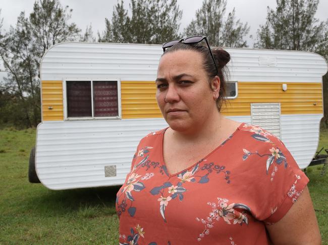 Karen Fullick’s family is staying in this caravan just metres from the blackened remains of their house. Picture: David Swift