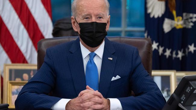 Joe Biden speaks from the Resolute Desk prior to signing executive orders related to immigration in the Oval Office. Picture: AFP.