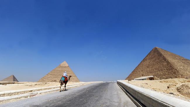 An Egyptian man looking for customers in front of the pyramids in Giza. Picture: AFP Photo/Fayez Nureldine