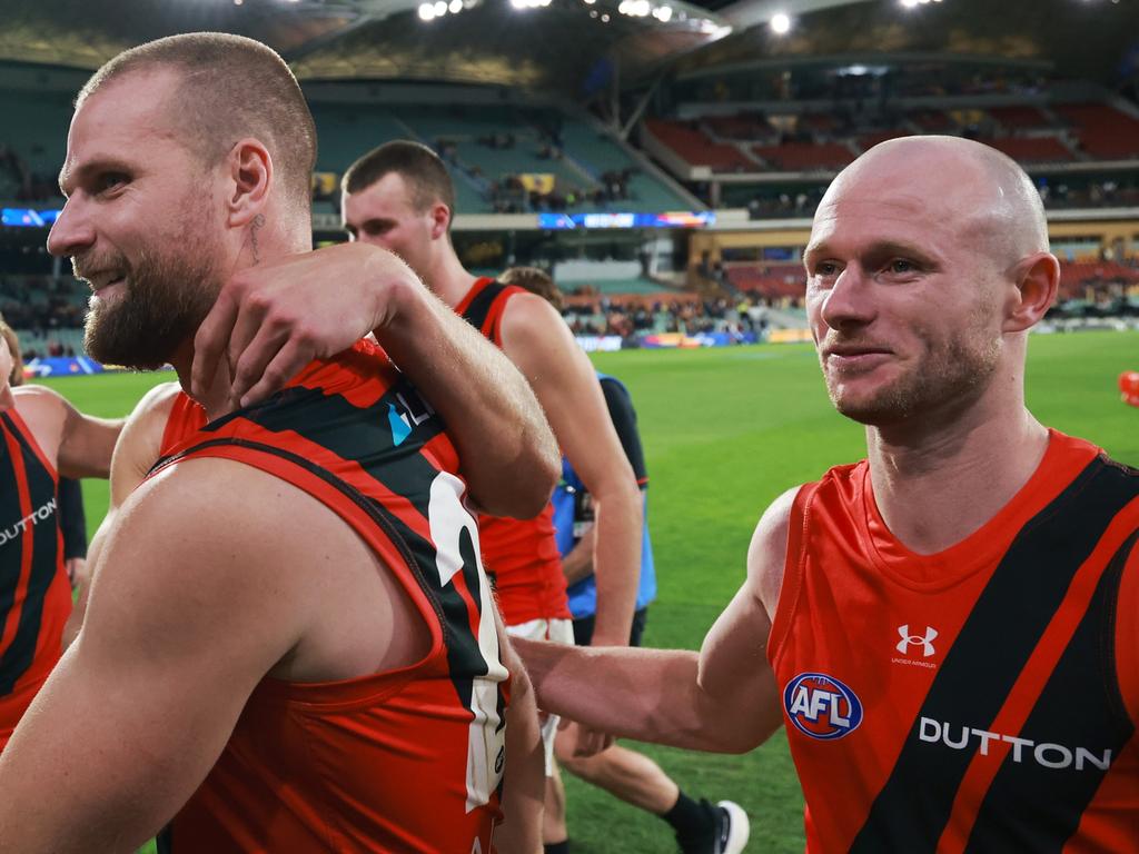 ADELAIDE, AUSTRALIA – APRIL 19: Jake Stringer and Nick Hind of the Bombers celebrate their win during the 2024 AFL Round 06 match between the Adelaide Crows and the Essendon Bombers at Adelaide Oval on April 19, 2024 in Adelaide, Australia. (Photo by James Elsby/AFL Photos via Getty Images)