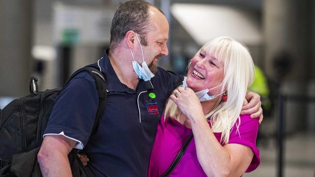 A couple is reunited at Sydney Airport. Picture: Nigel Hallett