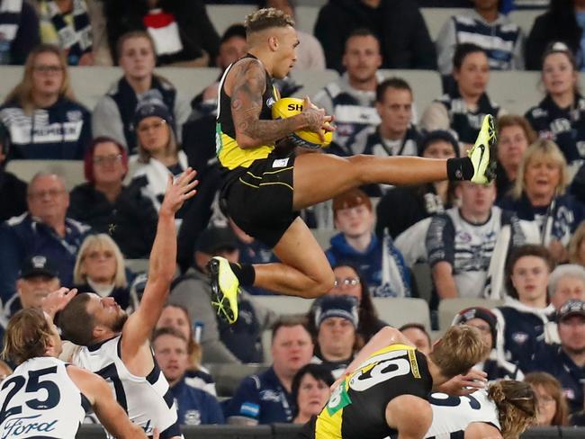 Shai Bolton launches into the night sky. Picture: Michael Willson/AFL Photos via Getty Images