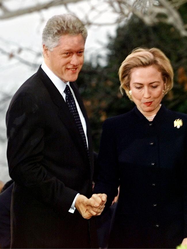 Then-president Bill Clinton holds hands with wife First Lady Hillary Rodham Clinton before a press conference about vote to impeach him on 19 Dec 1998. 