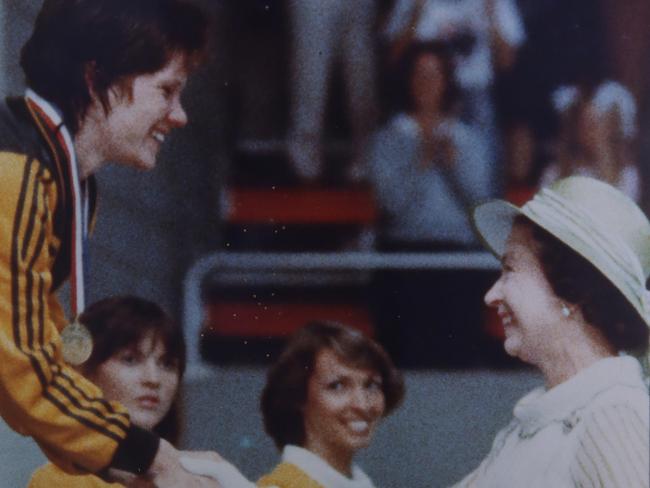 Teen swimming sensation from the 1982 Commonwealth games in Brisbane,  Tracey Wickham being presented  with her gold medal for the 400m freestyle , by Queen Elizabeth during the games