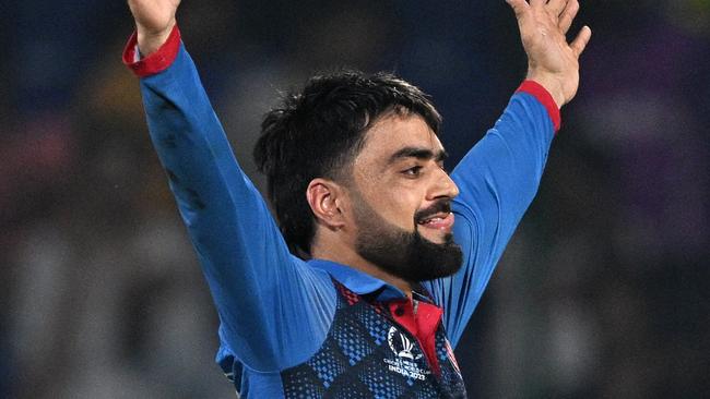 Afghanistan's Rashid Khan celebrates after taking the wicket of England's Mark Wood during the 2023 ICC Men's Cricket World Cup one-day international (ODI) match between England and Afghanistan at the Arun Jaitley Stadium in New Delhi on October 15, 2023. (Photo by Money SHARMA / AFP) / -- IMAGE RESTRICTED TO EDITORIAL USE - STRICTLY NO COMMERCIAL USE --