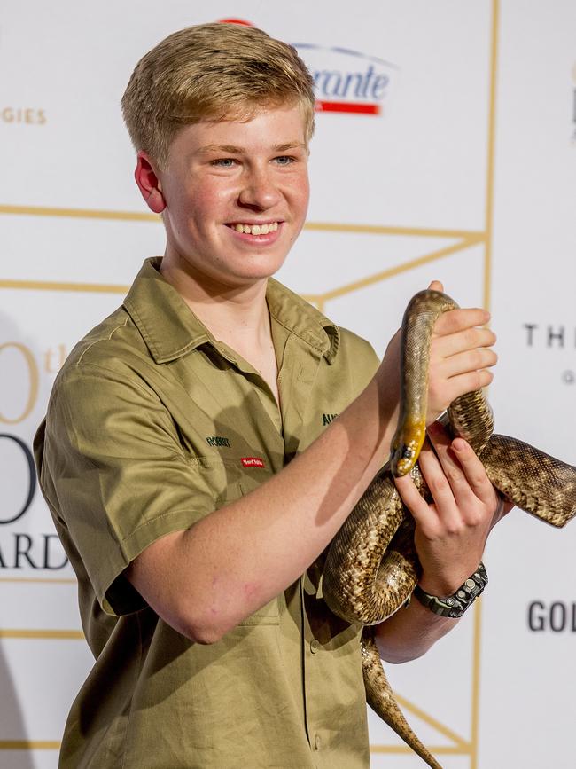 Robert Irwin holding a snake as he arrives at the event. Picture: Jerad Williams